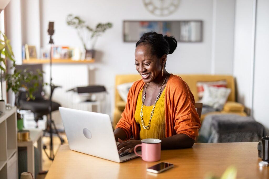 black woman sitting at computer, smiling