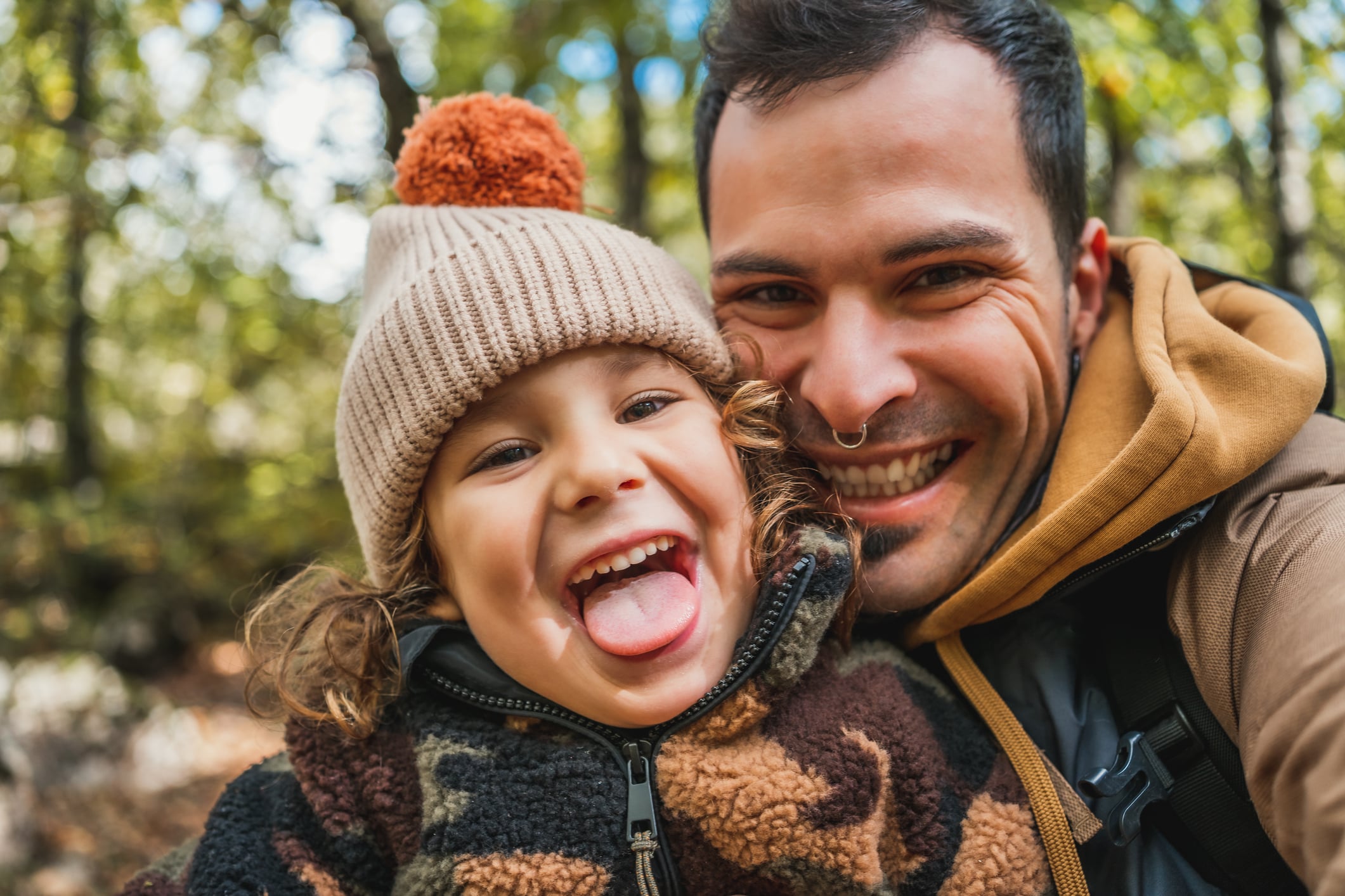 dad posing with daughter outdoors